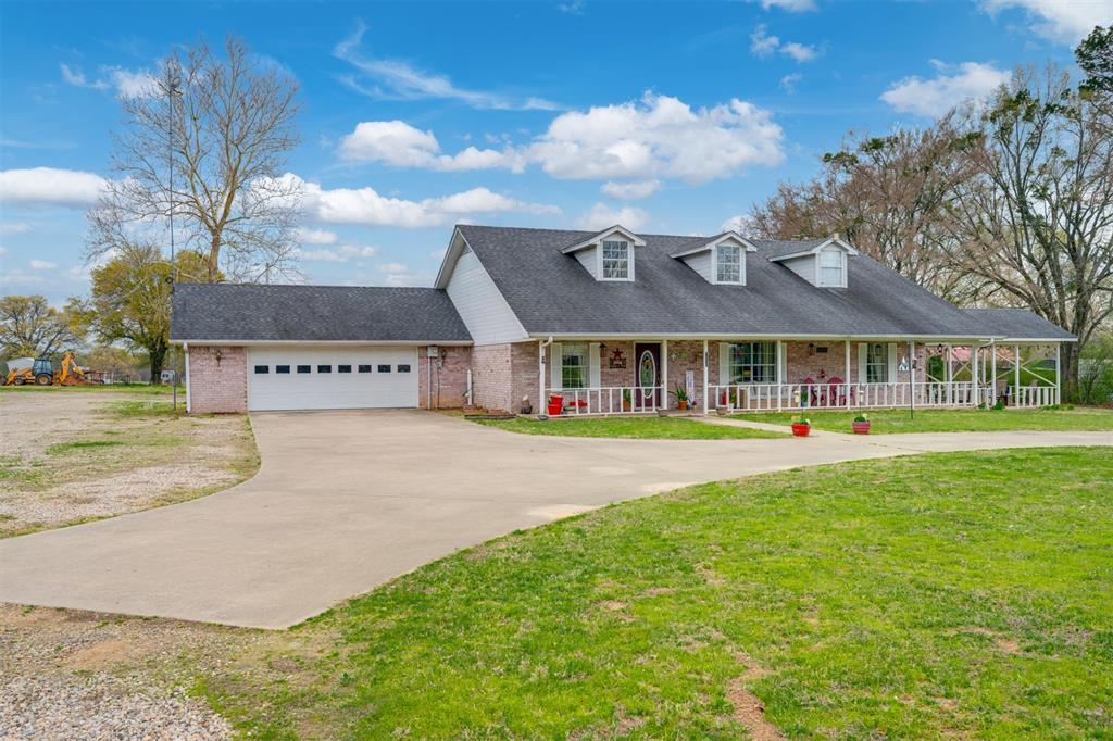 a front view of house with yard swimming pool and outdoor seating