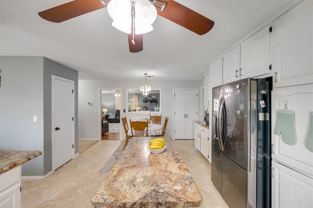 1876 Farm To Market 906 Powderly, TX 75473 - Photo 11 of 38 a kitchen with stainless steel appliances granite countertop a refrigerator a stove a sink and a refrigerator