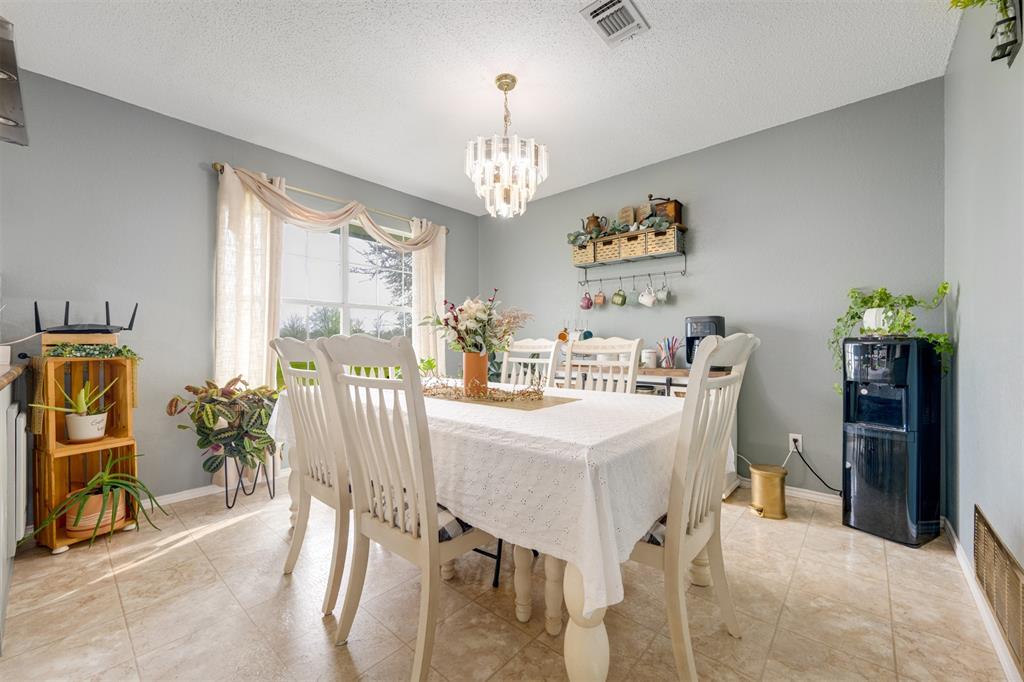 1876 Farm To Market 906 Powderly, TX 75473 - Photo 13 of 38 a view of a dining room with furniture and chandelier