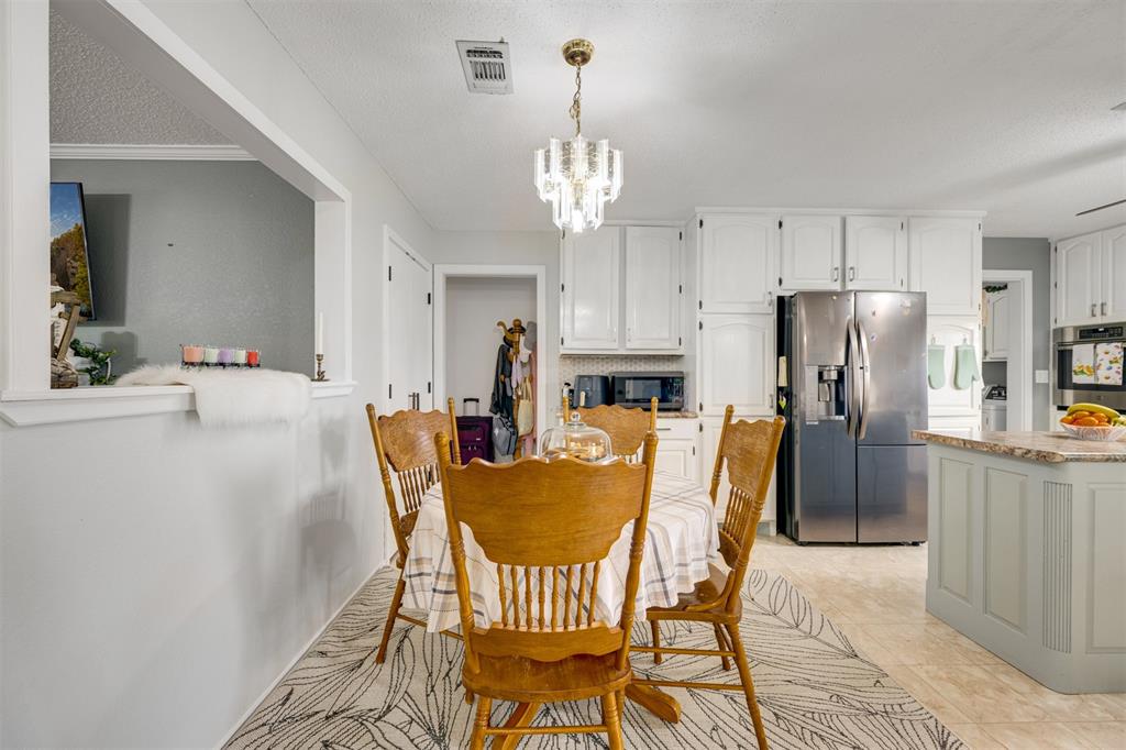 1876 Farm To Market 906 Powderly, TX 75473 - Photo 14 of 38 a view of a dining room with furniture and chandelier