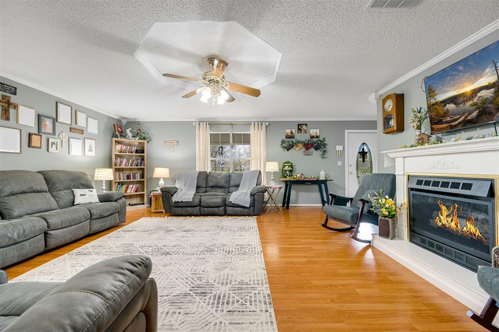 1876 Farm To Market 906 Powderly, TX 75473 - Photo 15 of 38 a living room with furniture and a fireplace