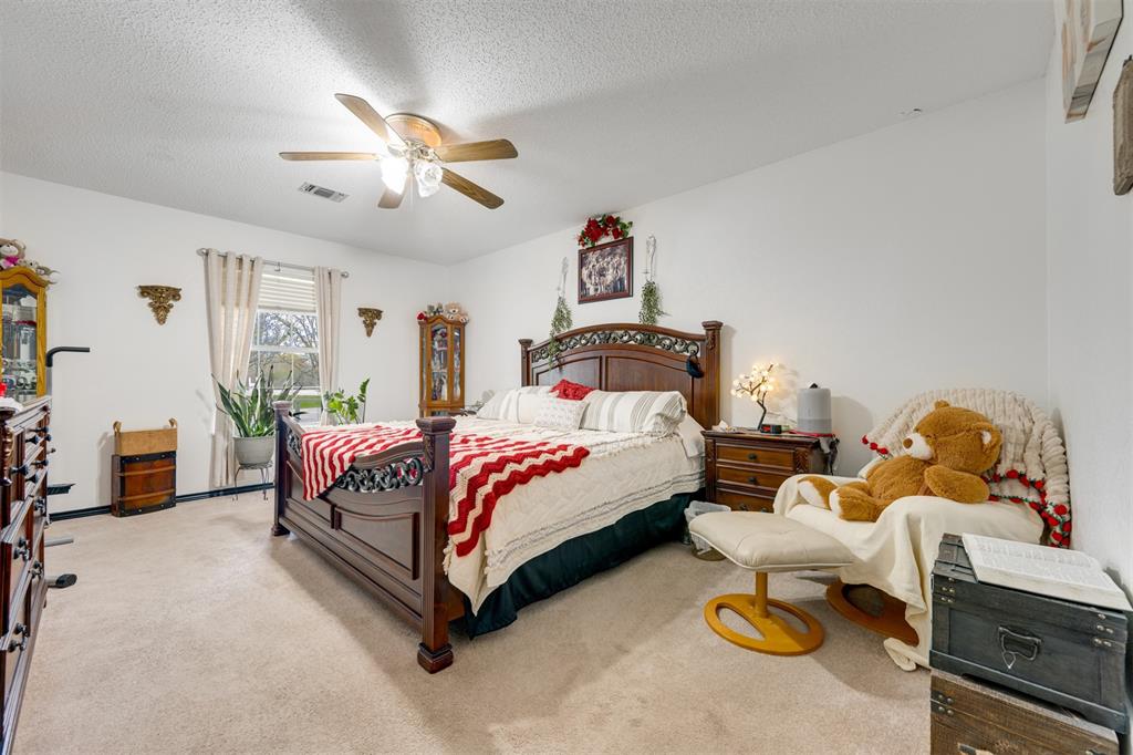 1876 Farm To Market 906 Powderly, TX 75473 - Photo 17 of 38 a bed room with a bed and a chandelier