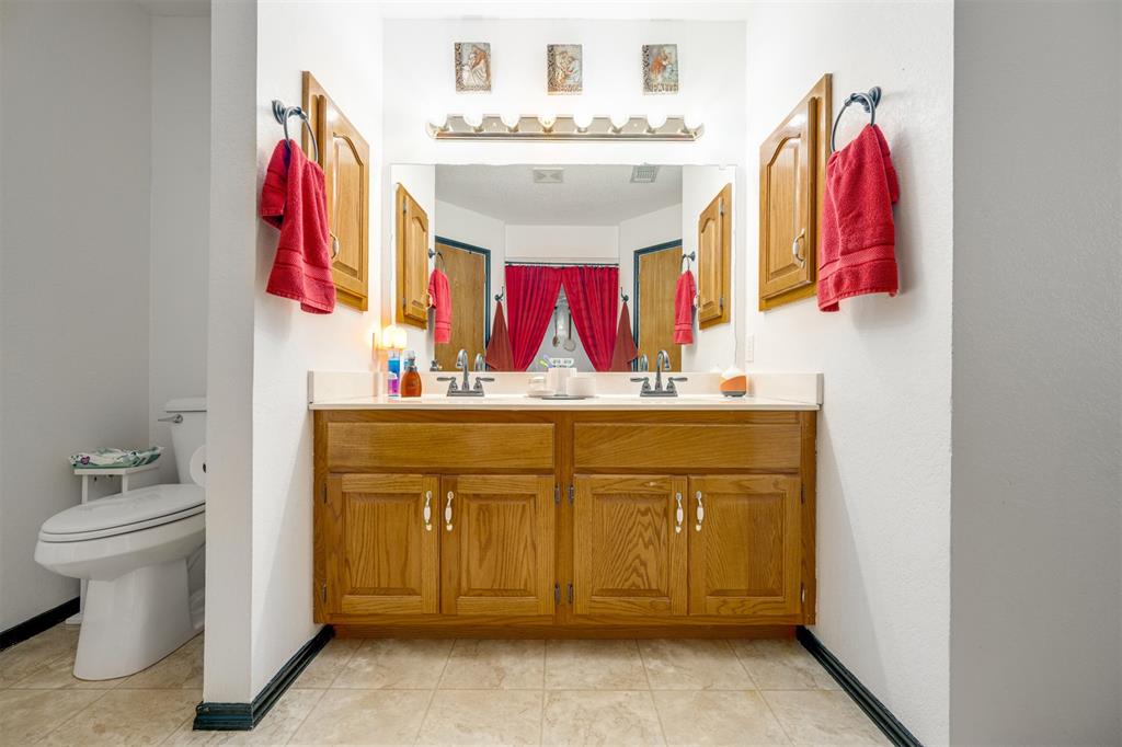1876 Farm To Market 906 Powderly, TX 75473 - Photo 19 of 38 a bathroom with a sink and a mirror