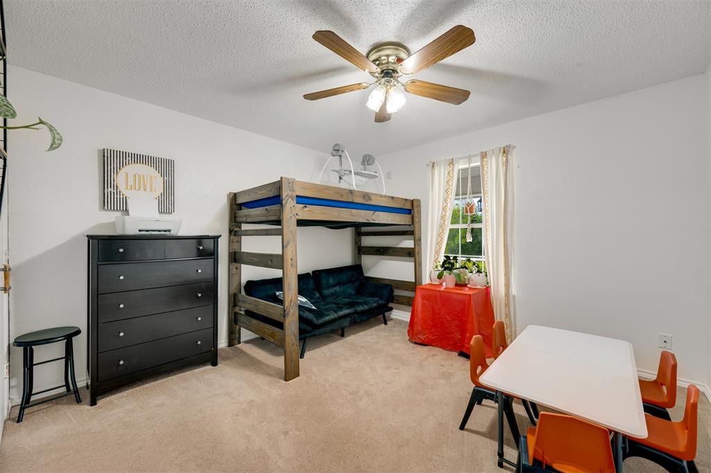 1876 Farm To Market 906 Powderly, TX 75473 - Photo 21 of 38 a bedroom with a bed and a chandelier