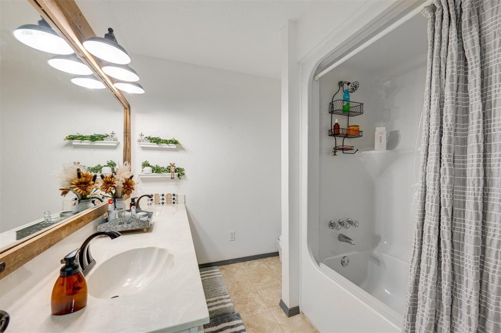 1876 Farm To Market 906 Powderly, TX 75473 - Photo 22 of 38 a bath tub sitting next to a bathroom sink and a tub