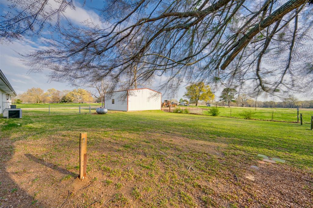 1876 Farm To Market 906 Powderly, TX 75473 - Photo 28 of 38 a view of a golf course with a big yard