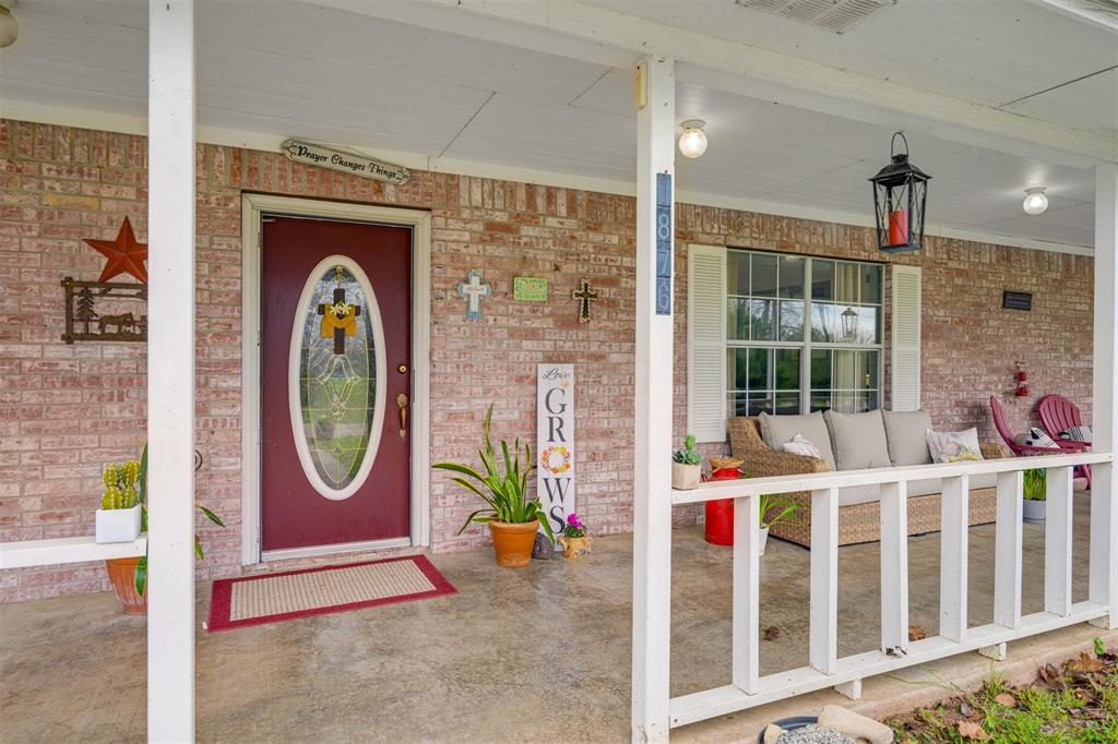 1876 Farm To Market 906 Powderly, TX 75473 - Photo 6 of 38 a view of a pathway of a building with a porch