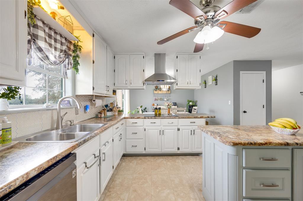 1876 Farm To Market 906 Powderly, TX 75473 - Photo 8 of 38 a kitchen with granite countertop a sink stainless steel appliances and cabinets