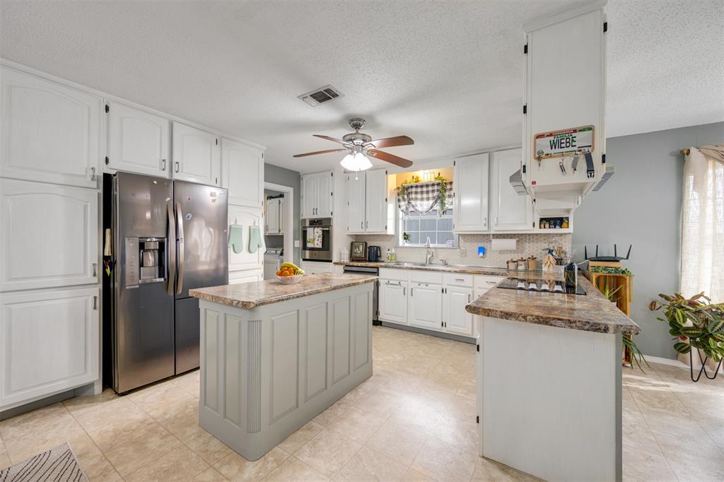 1876 Farm To Market 906 Powderly, TX 75473 - Photo 10 of 38 a kitchen with cabinets and stainless steel appliances