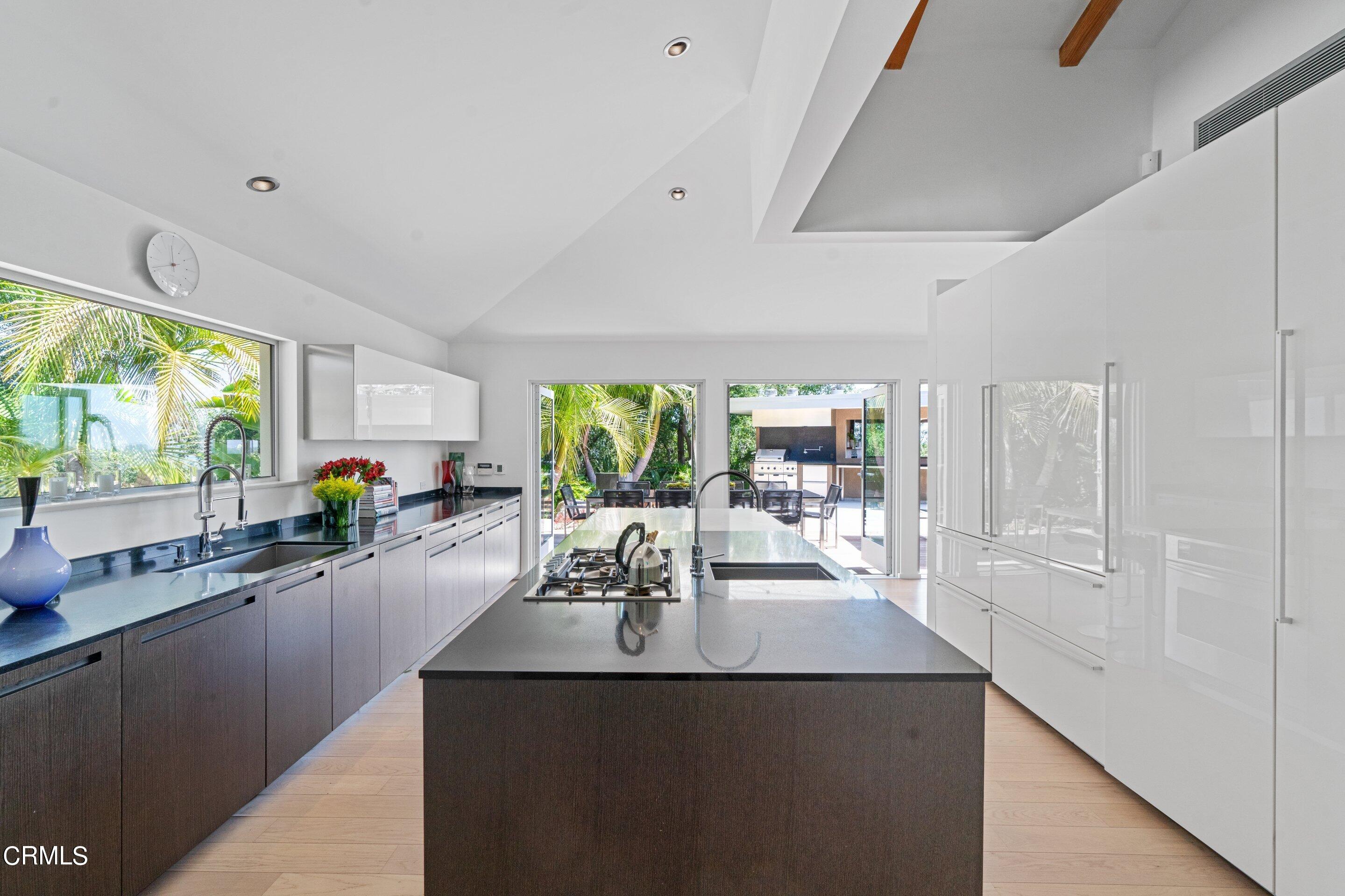 1460 Linda Ridge Road Pasadena, CA 91105 - Photo 13 of 63 a view of a kitchen with kitchen island a large window cabinets a sink and stainless steel appliances