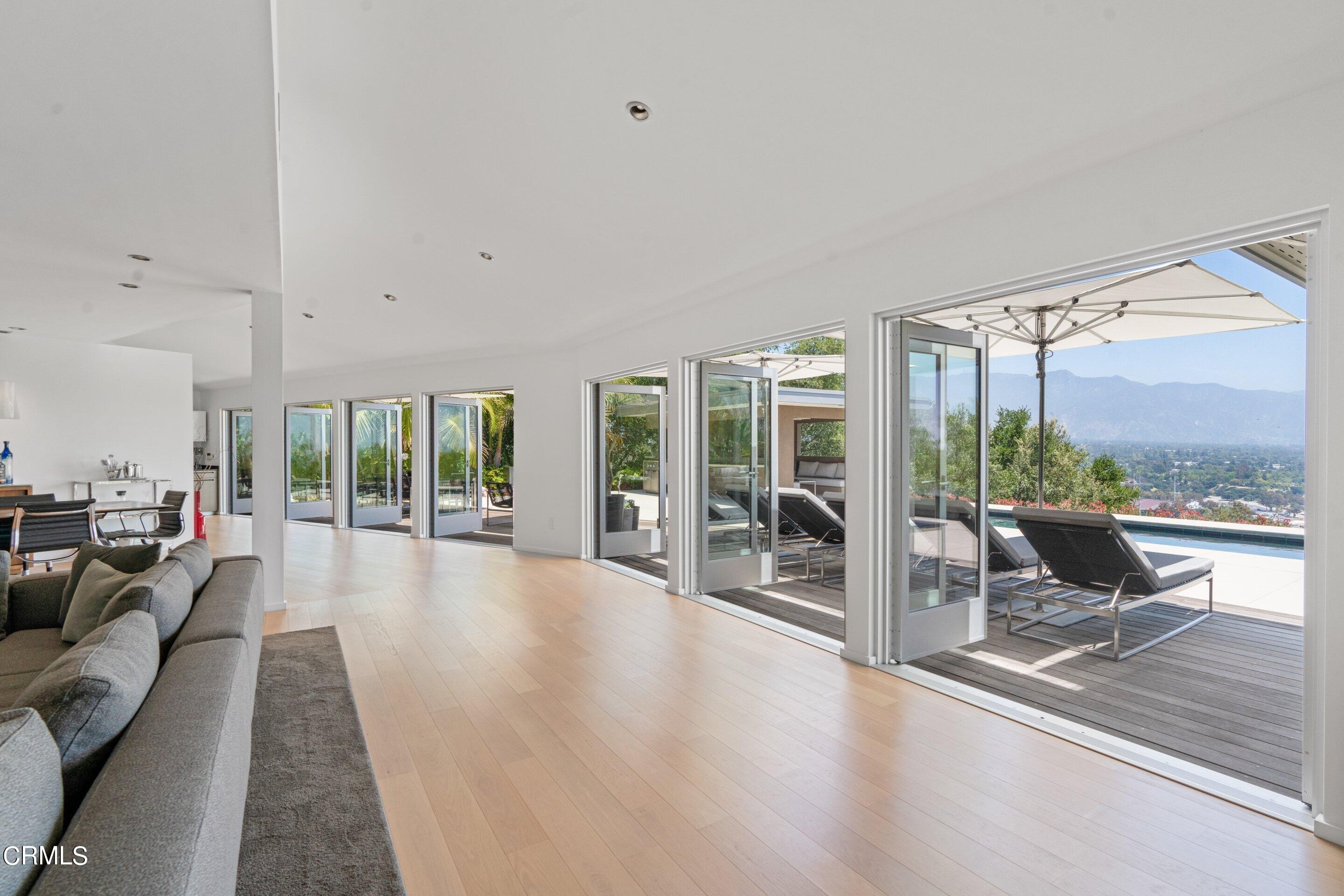 1460 Linda Ridge Road Pasadena, CA 91105 - Photo 20 of 63 a living room with furniture large windows and wooden floor