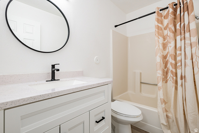 1221 Waterside Cove, Unit 11 Midvale, UT 84047 - Photo 11 of 23 Bathroom featuring a white vanity with flat-panel doors, a white countertop with an integrated sink, and a matte black single-handle faucet