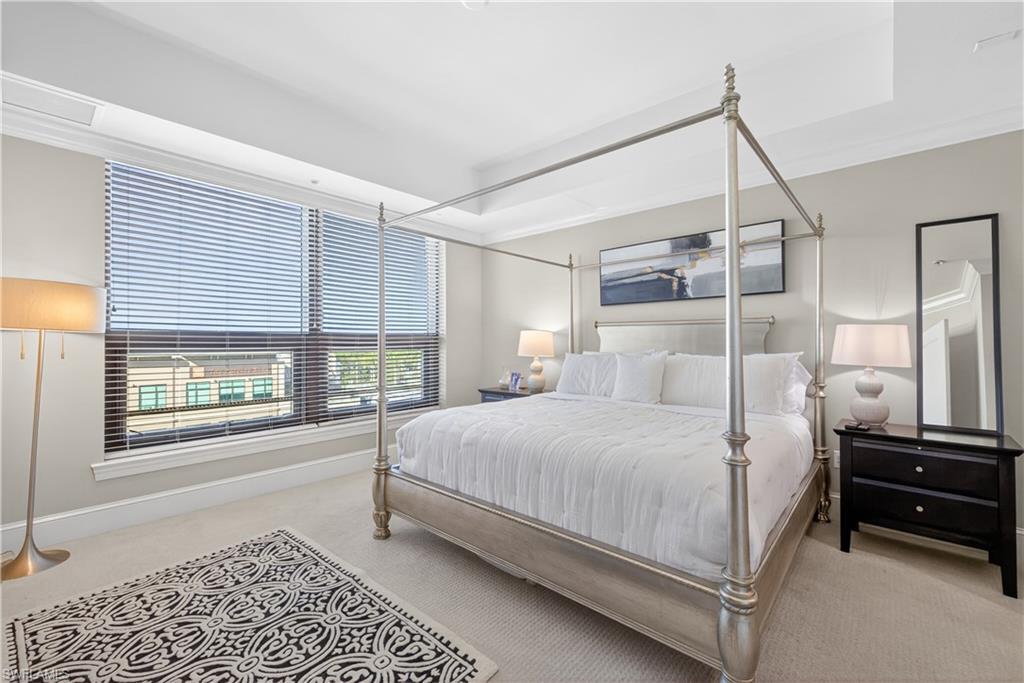 9115 Strada Place, Unit 5504 Naples, FL 34108 - Photo 8 of 22 a bedroom with a bed next to a window