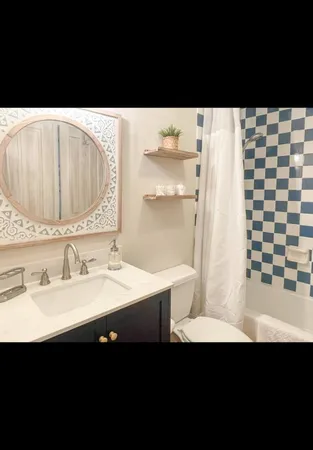 a view of a bedroom with furniture and window