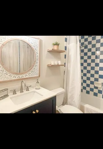 a view of a bedroom with furniture and window