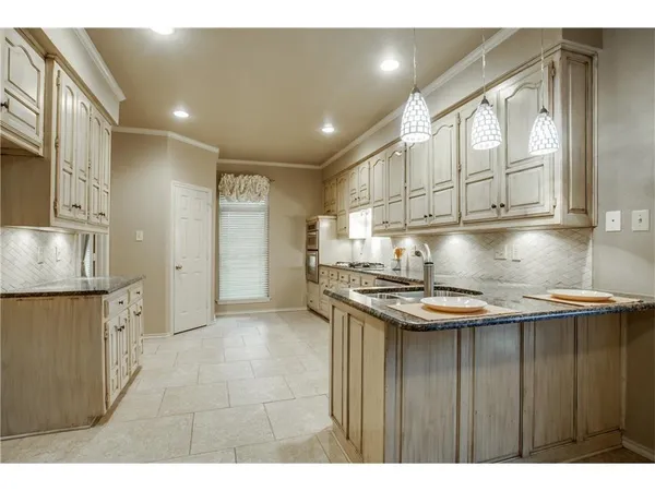 a kitchen with stainless steel appliances granite countertop a sink stove and cabinets