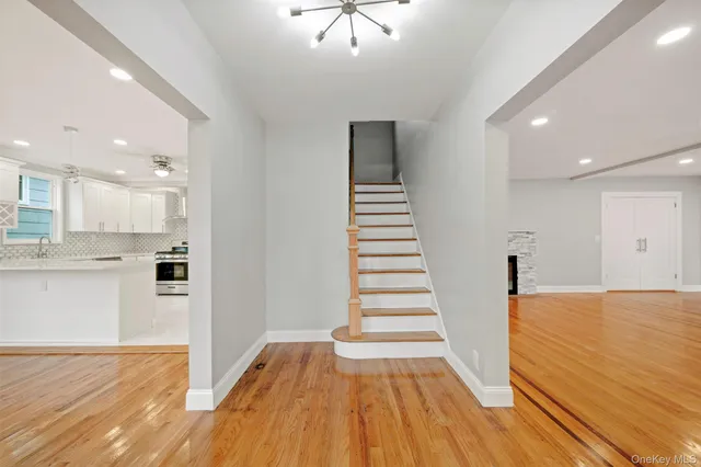 a view of a kitchen with wooden floor and a sink