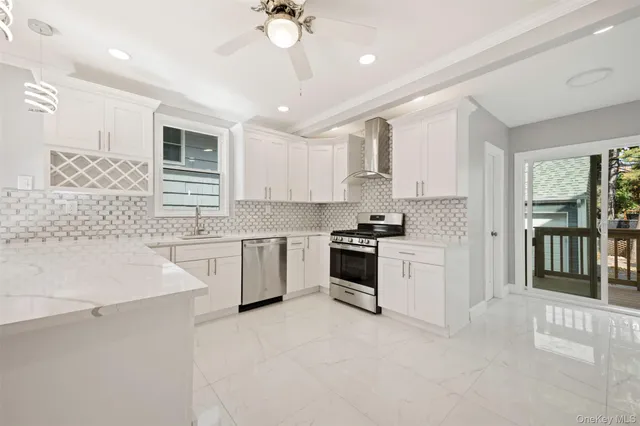 a kitchen with granite countertop white cabinets and white appliances