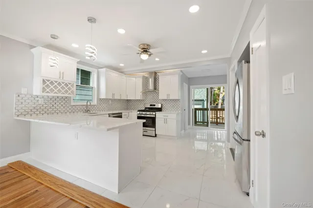 a kitchen with stainless steel appliances granite countertop a refrigerator and a sink