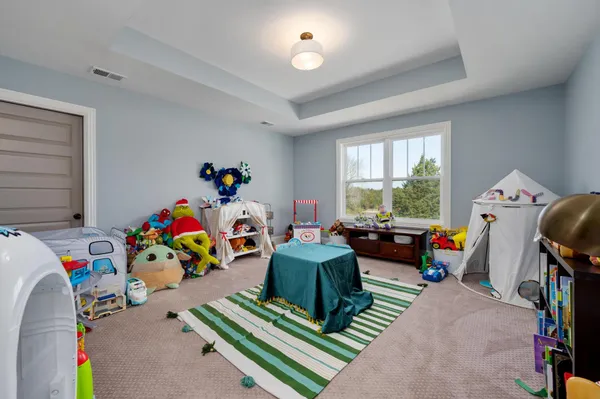 a living room with furniture gym equipment and a chandelier