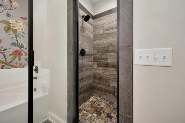 a bathroom with a glass shower door