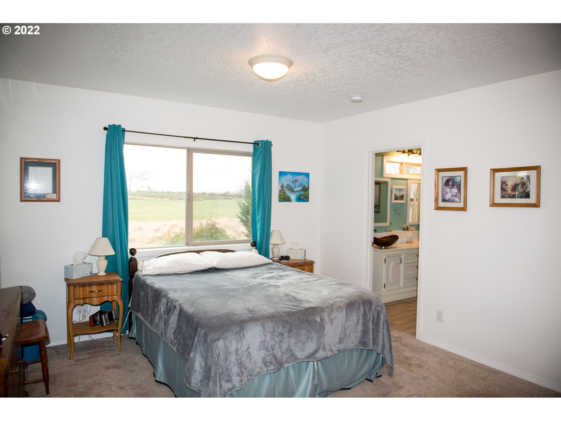 24550 Southwest Tile Flat Road Hillsboro, OR 97123 - Photo 10 of 32 a bedroom with a bed window and a table