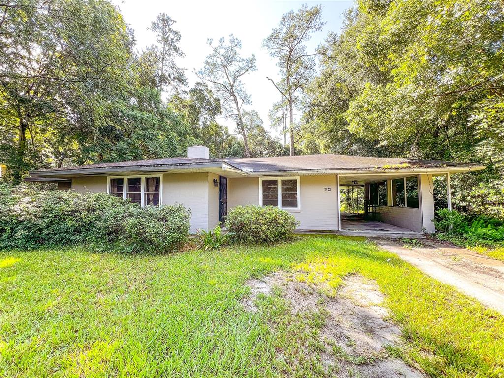 a view of house with swimming pool and a chairs and tables in patio