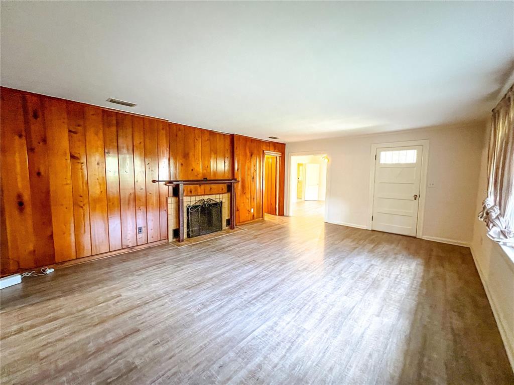 1403 Northwest 11th Road Gainesville, FL 32605 - Photo 2 of 15 an empty room with wooden floor and windows