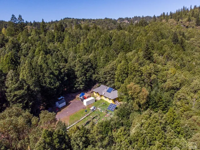 an aerial view of a house with a yard
