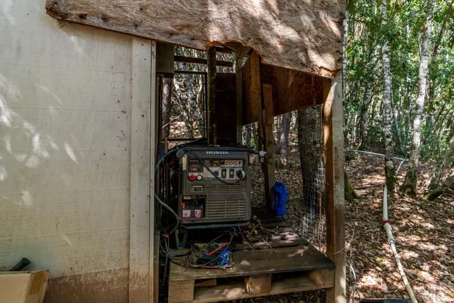 a view of a backyard with a sink and a wooden fence