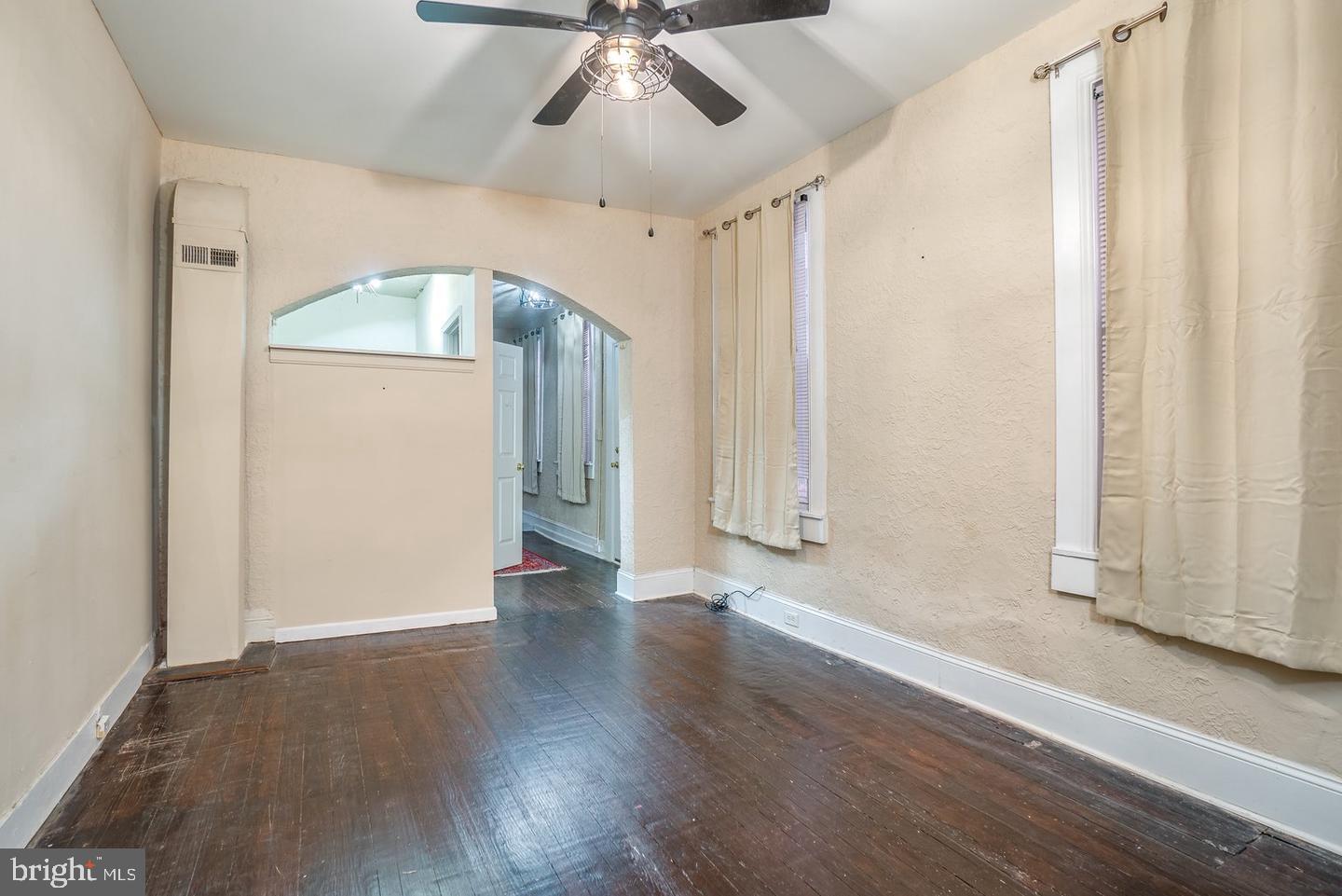 1420 Light Street, Unit 1R Baltimore, MD 21230 - Photo 4 of 8 a view of an empty room with wooden floor and a window