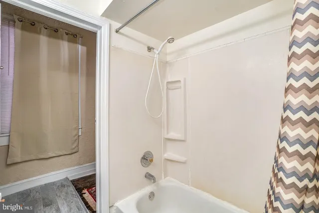 a bathroom with a shower curtain and a sink