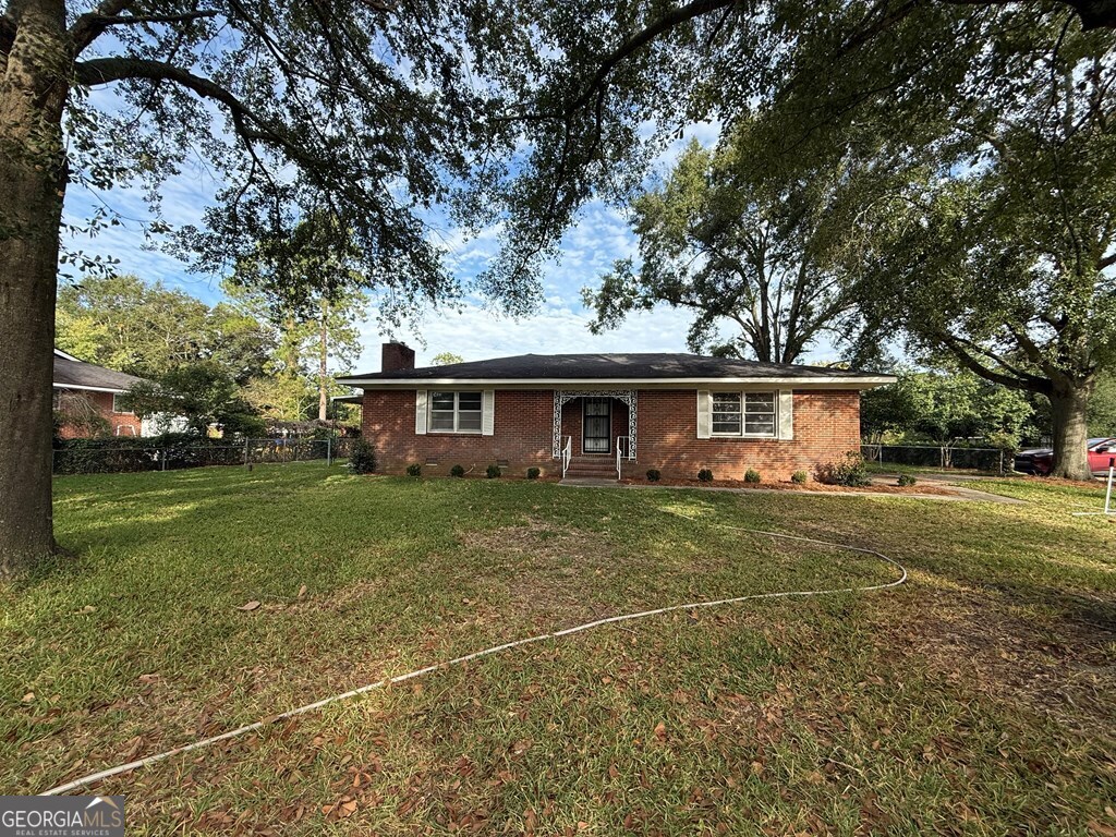 412 Roberson Street Dublin, GA 31021 - Photo 17 of 54 a front view of a house with a yard