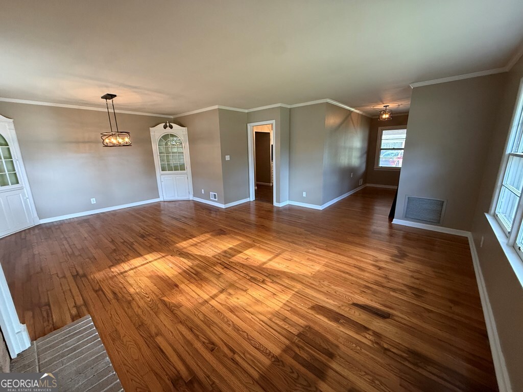412 Roberson Street Dublin, GA 31021 - Photo 19 of 54 a bedroom with a bed and a mirror