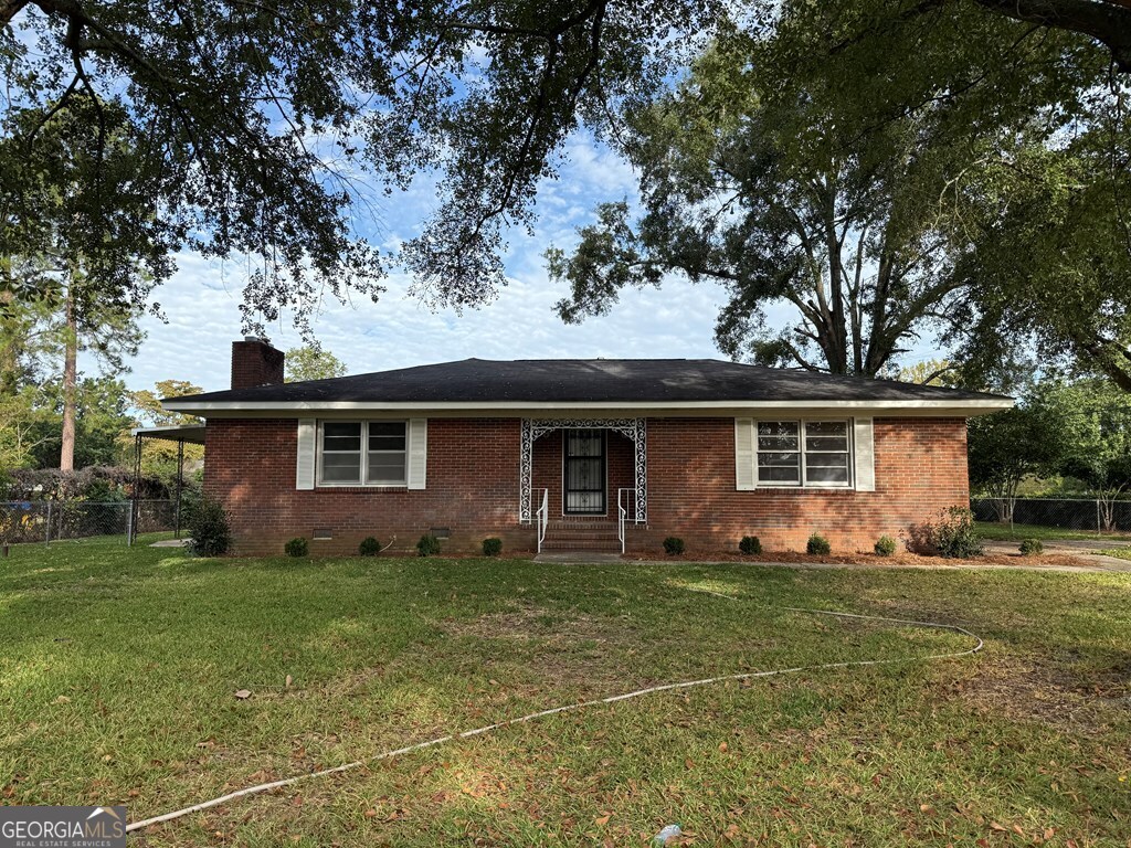 412 Roberson Street Dublin, GA 31021 - Photo 2 of 54 a front view of a house with yard and trees