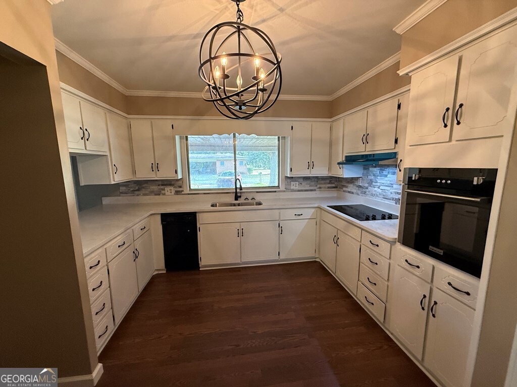 412 Roberson Street Dublin, GA 31021 - Photo 22 of 54 a white kitchen with a sink a window and stainless steel appliances