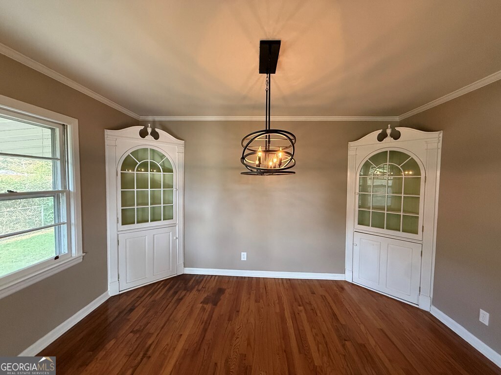 412 Roberson Street Dublin, GA 31021 - Photo 24 of 54 an empty room with wooden floor and windows