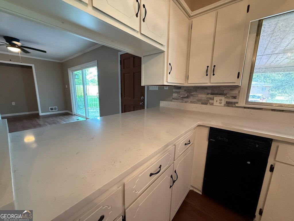 412 Roberson Street Dublin, GA 31021 - Photo 27 of 54 a kitchen with granite countertop white cabinets and white appliances