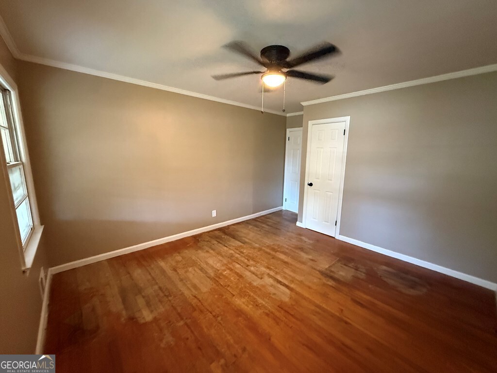 412 Roberson Street Dublin, GA 31021 - Photo 33 of 54 an empty room with wooden floor and windows