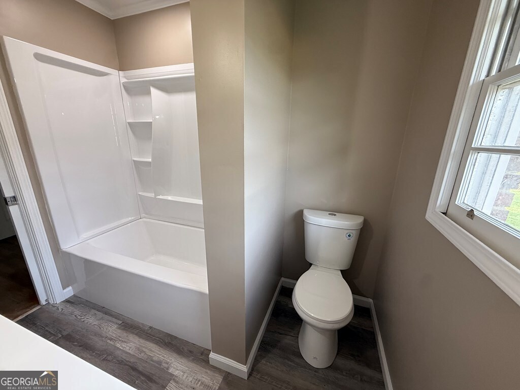 412 Roberson Street Dublin, GA 31021 - Photo 34 of 54 a bathroom with a toilet and a shower