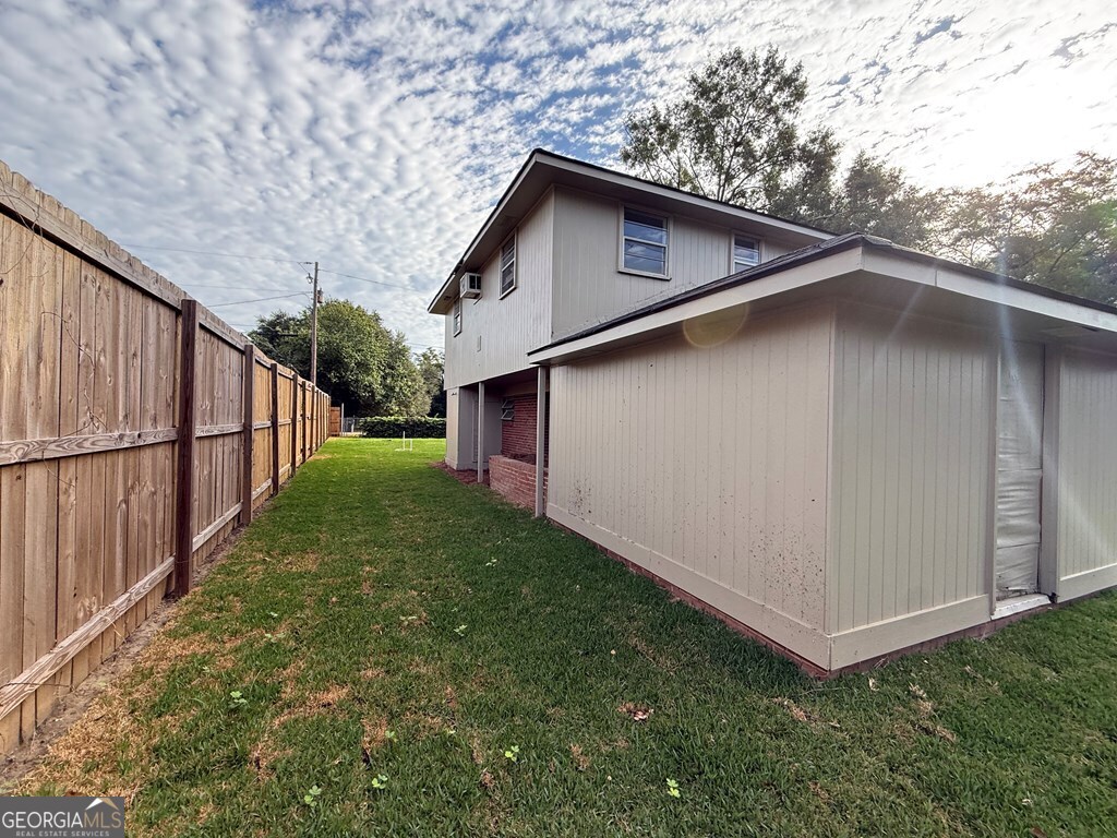 412 Roberson Street Dublin, GA 31021 - Photo 43 of 54 a white house with a yard in the back