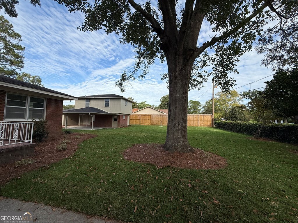 412 Roberson Street Dublin, GA 31021 - Photo 7 of 54 a view of a house with a yard and an tree