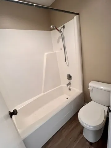 a bathroom with a toilet and a bathtub