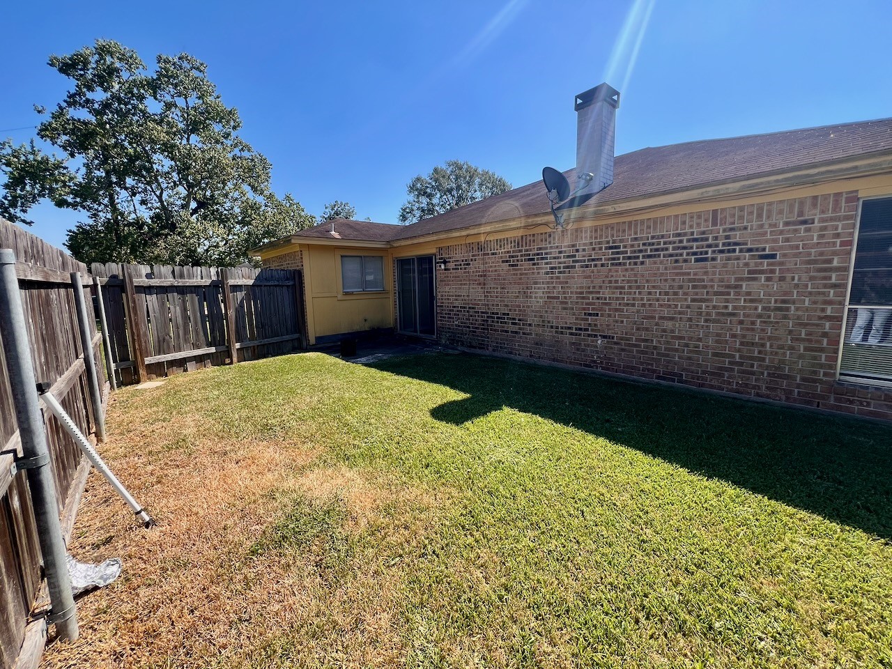 1650 Shirley Circle Beaumont, TX 77707 - Photo 14 of 14 a backyard of a house with wooden fence