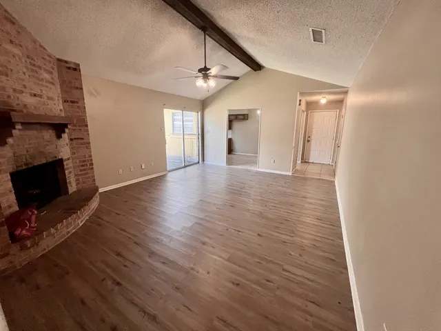 wooden floor in an empty room with a fireplace