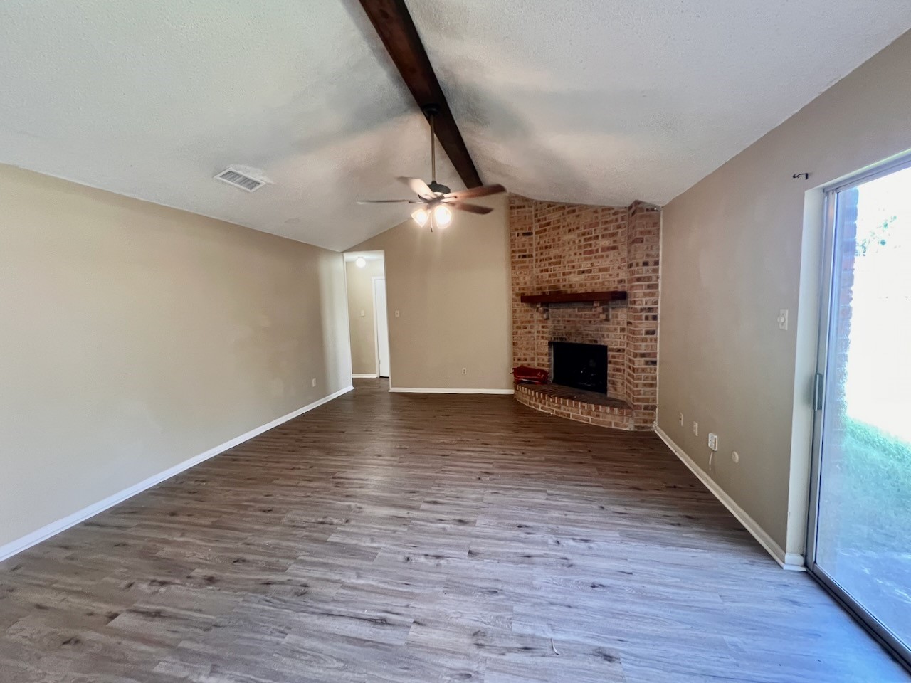 1650 Shirley Circle Beaumont, TX 77707 - Photo 4 of 14 wooden floor in an empty room with a fireplace