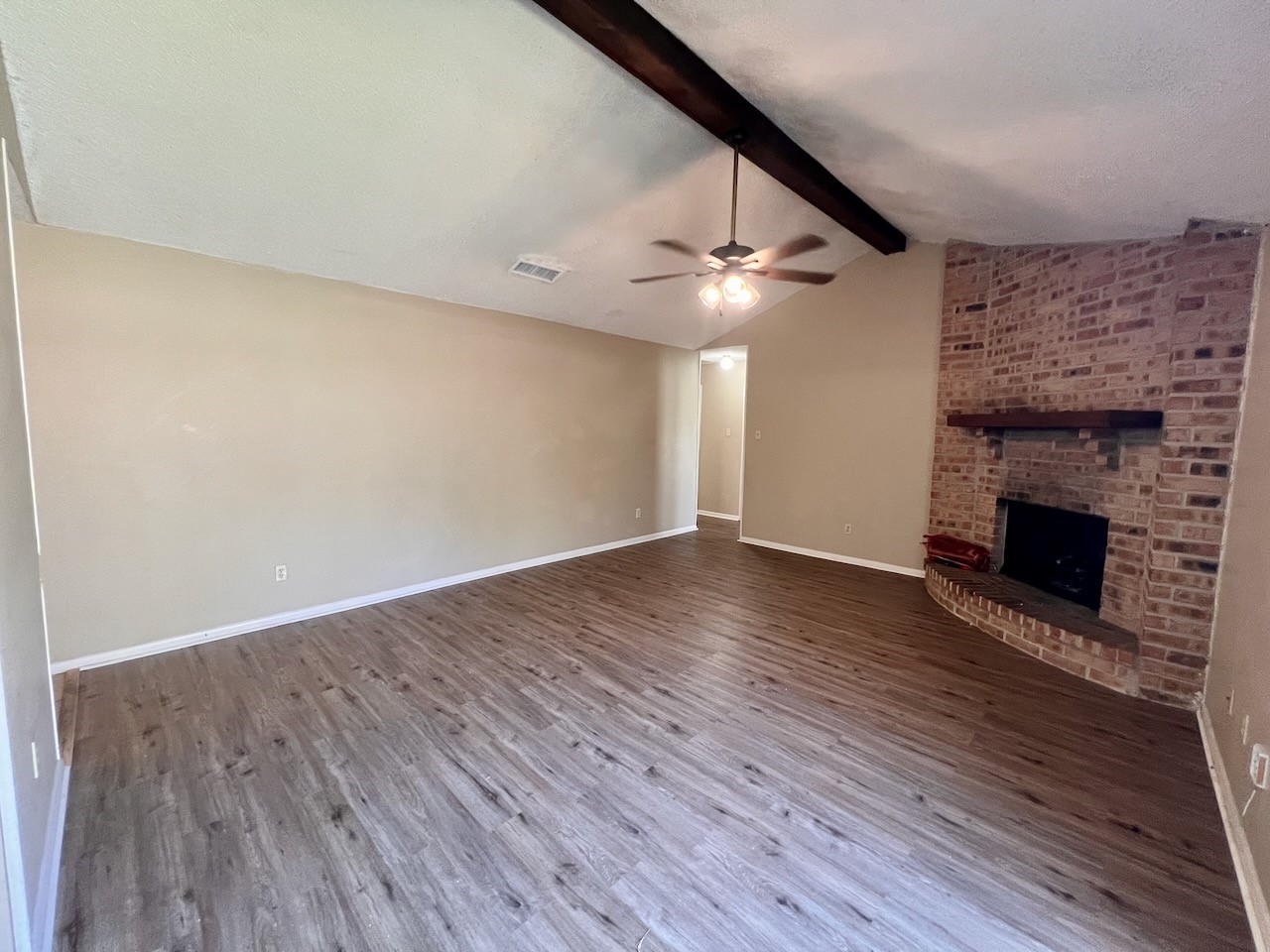 1650 Shirley Circle Beaumont, TX 77707 - Photo 5 of 14 a view of an empty room with wooden floor fireplace and a window
