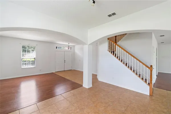a view of an empty room with wooden floor