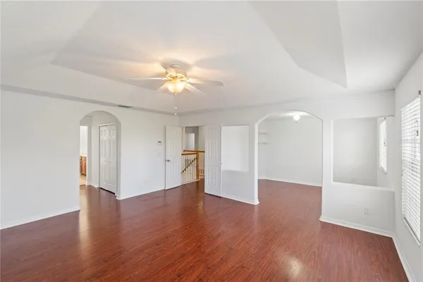 an empty room with wooden floor and window
