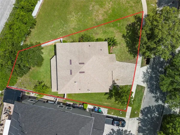 an aerial view of a house with a yard and pool